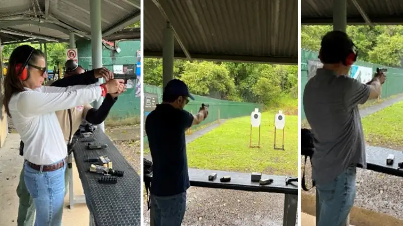 People practicing handgun shooting at an outdoor range with paper targets.
