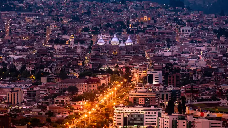 City of Cuenca, Ecuador at night, showcasing urban life.
