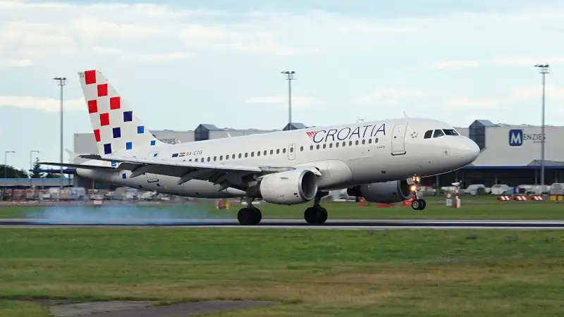 Croatia airline plane landing at Prague airport in beautiful evening light.