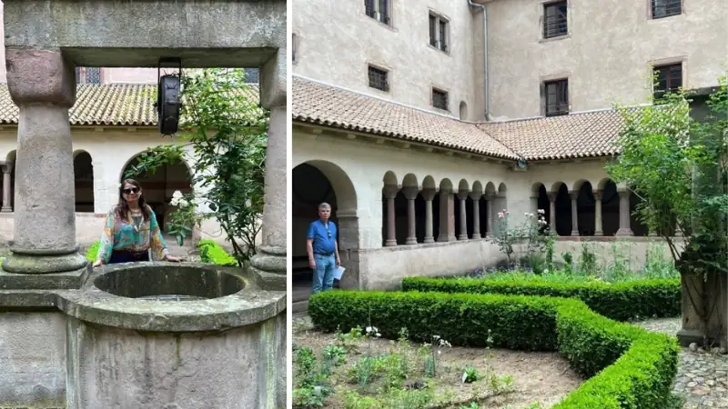 Kathleen and Lief exploring a historic monastery cloister, with Kathleen standing beside a stone well and Lief walking through the peaceful courtyard garden.