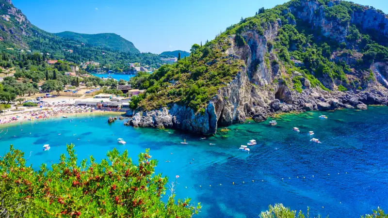 Agios Spiridon Beach with crystal clear azure water and white beach in beautiful landscape scenery - paradise coastline of Corfu island at Paleokastritsa, Ionian archipelago, Greece.