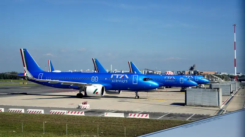 Airways passenger aircraft parked on an airport tarmac, symbolizing travel and arrival in Italy