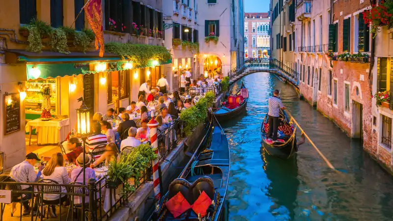 Canal in Venice, Italy at night showing reflections and canals