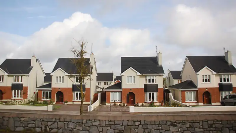 Scenic view of identical cottages nestled in an Irish landscape