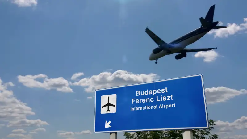 Airplane landing at Budapest Ferenc Liszt International Airport with visible signage