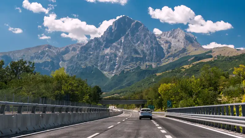 An highway in Italy; the mountain Gran Sasso in background