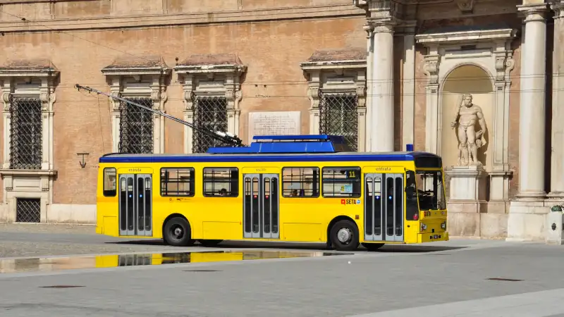 Trolleybus passing through a piazza in Modena, Italy