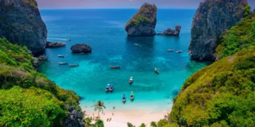 Turquoise lagoon with white coral sand Nui beach. Landscape koh Phi Phi Don island, Krabi, Thailand Aerial drone photo