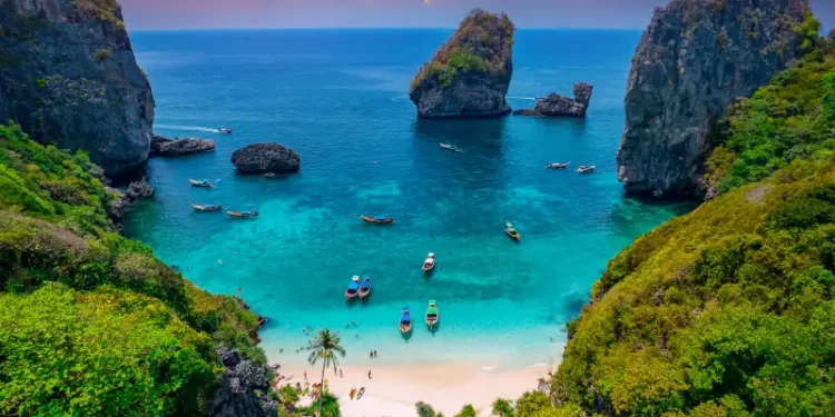 Turquoise lagoon with white coral sand Nui beach. Landscape koh Phi Phi Don island, Krabi, Thailand Aerial drone photo