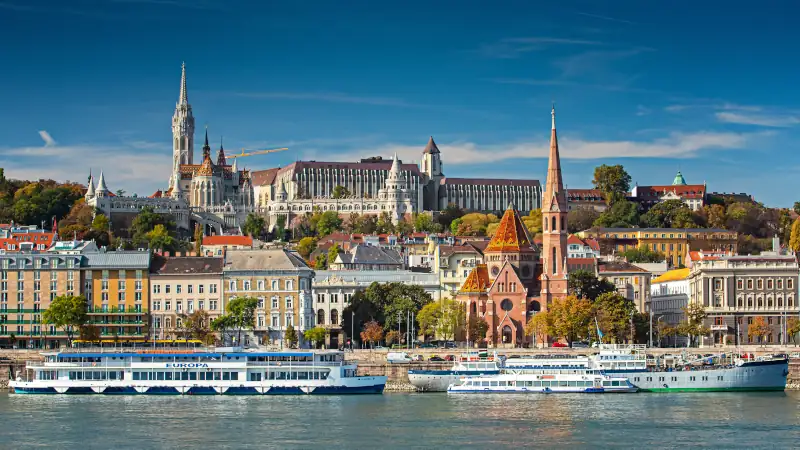 Autumn view on the riverbank of Budapest, showing colorful foliage and city backdrop