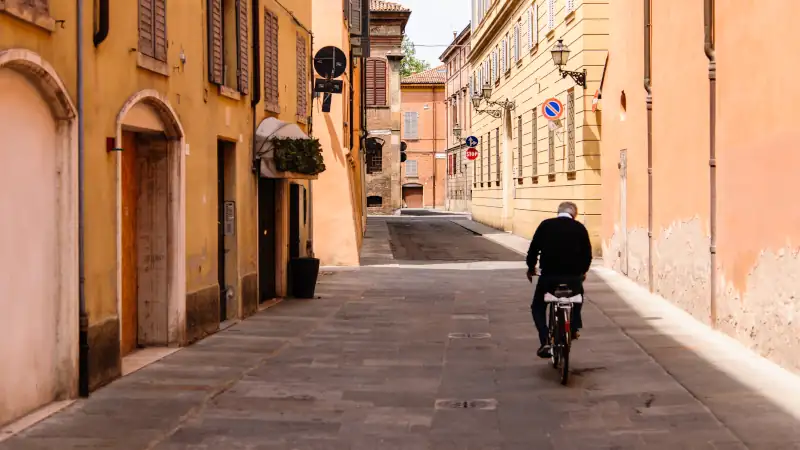 Cyclist viewing views of Modena from a scenic spot