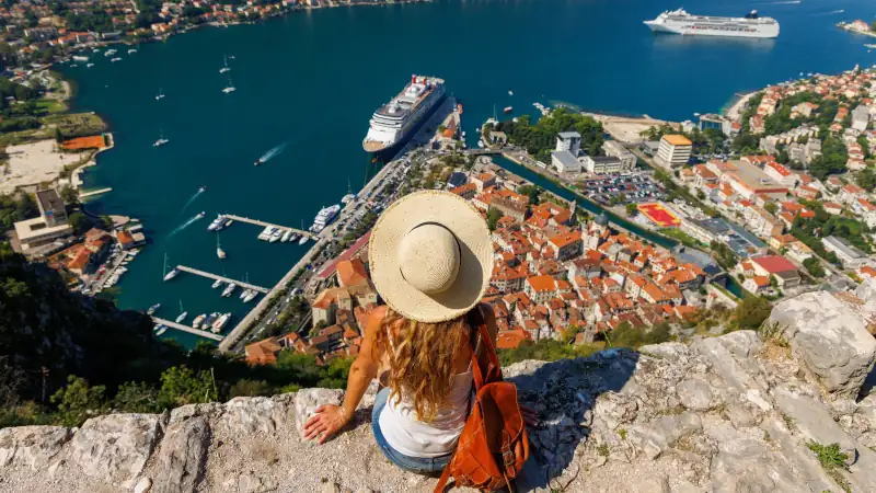 female looking at panoramic view of Kotor Bay