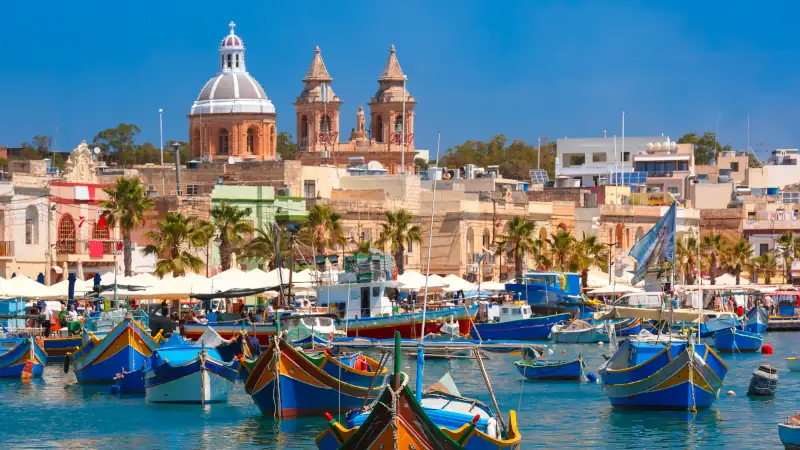 Fishing harbor in Marsaxlokk, Malta, showcasing traditional boats.