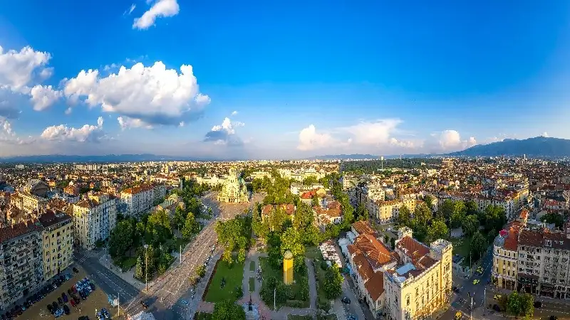 Panoramic view of Sofia, Bulgaria, with the city center and mountains in the distance.