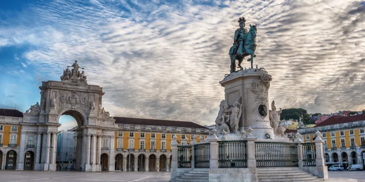 Lisbon, Portugal: the Triumphal Rua Augusta Arch, Arco Triunfal da Rua Augusta, Praca do Comercio and Statue of King Jose I at sunrise