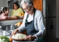 Hispanic grandmother cooking at home kitchen in Mexico Latin America