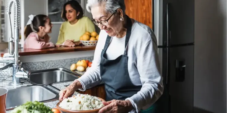 Hispanic grandmother cooking at home kitchen in Mexico Latin America