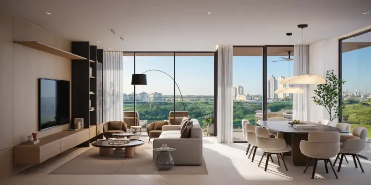 Contemporary luxury apartment featuring an open-plan living and dining area, warm neutral tones, elegant furnishings, floor-to-ceiling windows, and panoramic views of lush greenery and the city skyline.