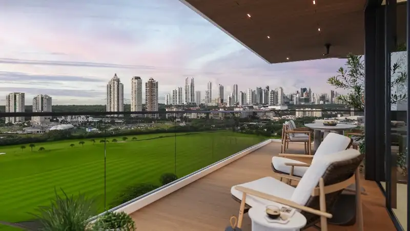 Contemporary luxury residences featuring expansive glass balconies, elegant outdoor living spaces, and illuminated interiors overlooking a scenic golf course at dusk.