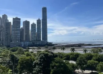 Panama City skyline overlooking the Pacific Ocean, with modern high-rise buildings along the waterfront.