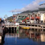 Boats docked at a pier with colorful structures