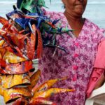 A lady holds masks made for carnival in the Dominican Republic.
