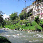 The river runs past colonial houses in Cuenca, Ecuador.