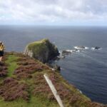 Cyclists enjoy the view from the rugged Irish coast.