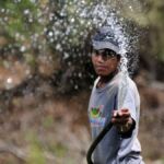 A gardener directs his hose at the camera in Granada, Nicaragua.