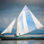 A local family sail a traditional boat around the San Blas Islands, Panama.