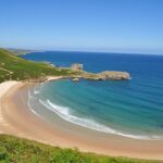 The golden sand of Torimbia beach in Spain.