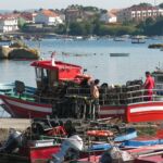 Fishing boats come into port in Spain.