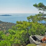 A hiker rests on a cliff overlooking the Marmara sea in Turkey.