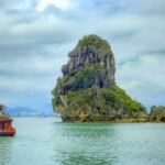 A boat cruises through Ha Long Bay, Vietnam.
