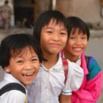 Vietnamese school girls laughing.