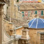 View from behind of the cathedral of Santa Maria in Murcia, Spain, with the episcopal palace in the background and, in the foreground, one of the side facades of the cathedral