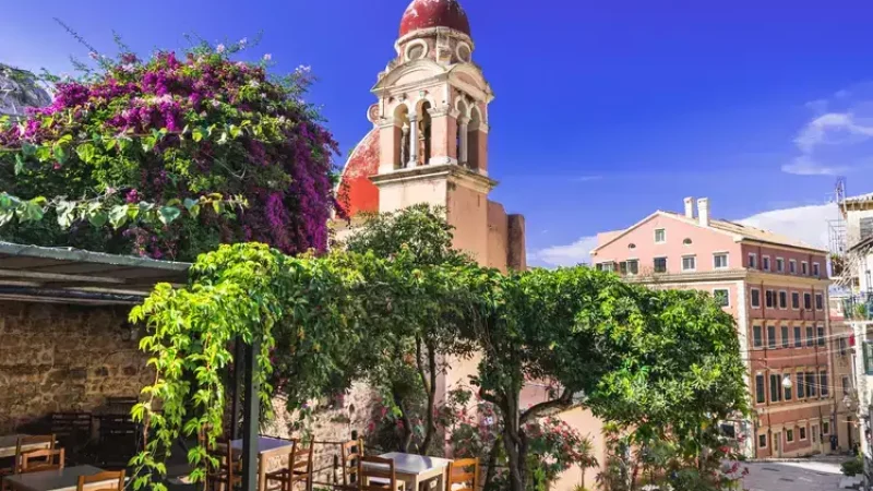 Street with cafe and flowers, in the island of Corfu