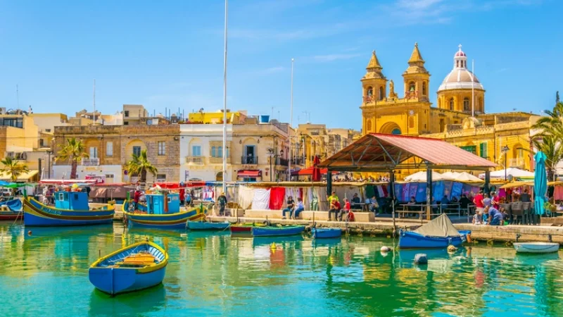 Colorful fishing boats moor in Marsaxlokk, Malta. health care in malta